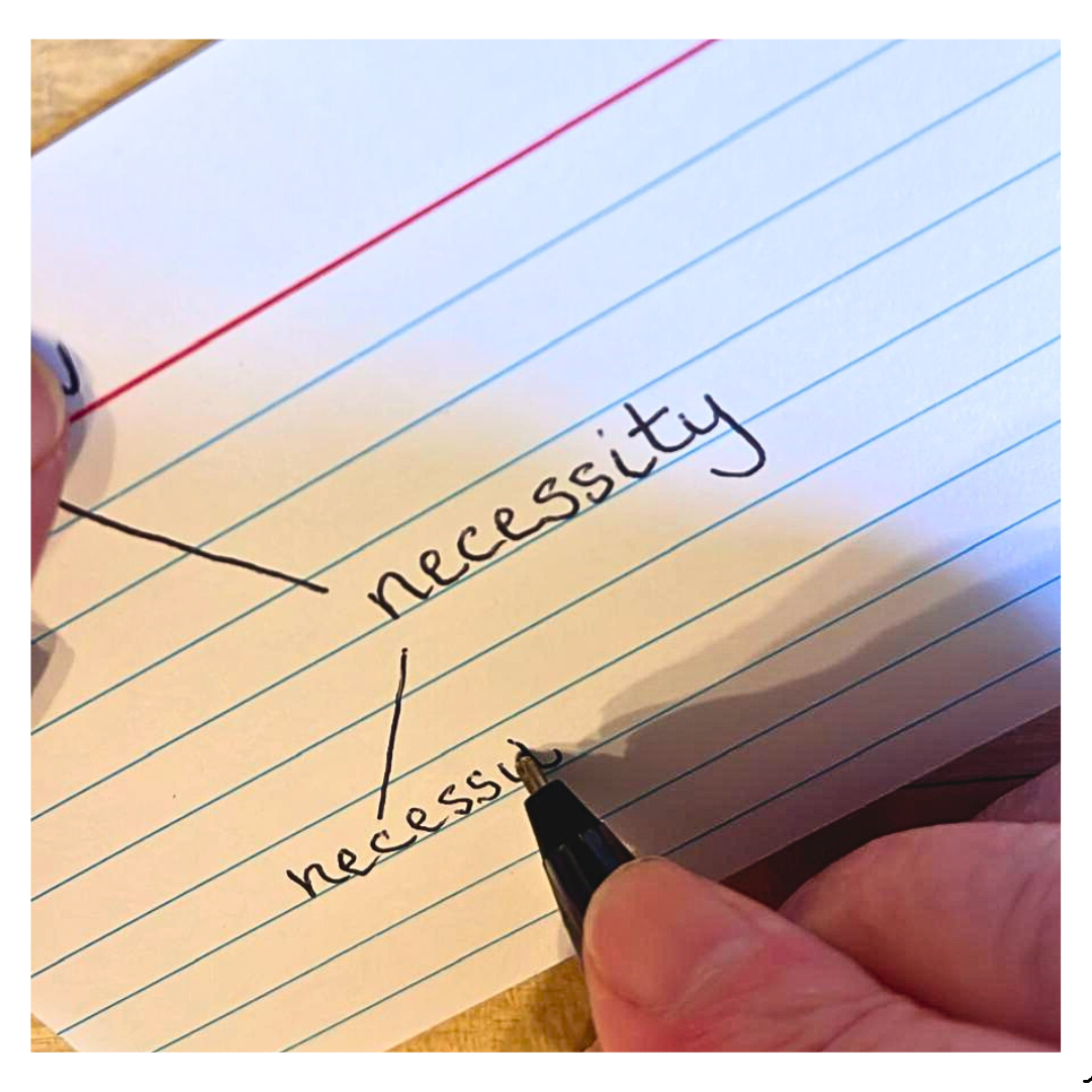 An IELTS student preparing to boost their vocabulary by writing words on a flashcards.