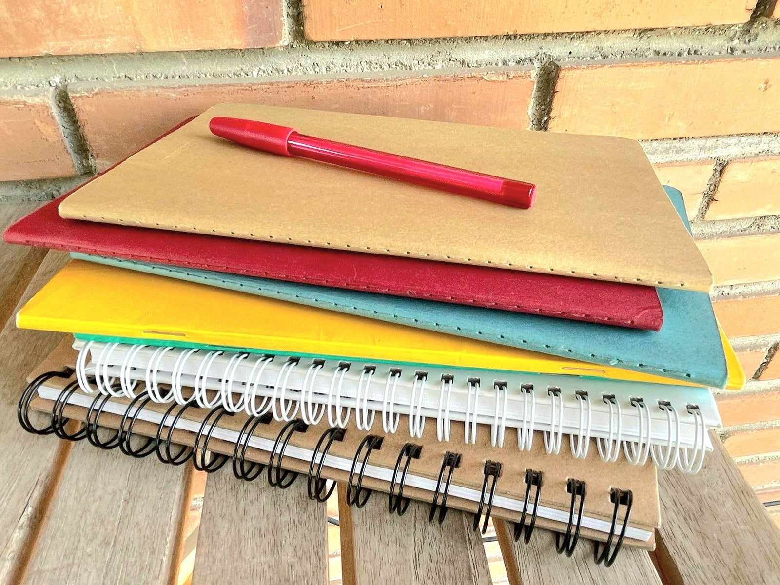 Image of a pile of books containing strategies for achieving Band 7 + in IELTS Reading